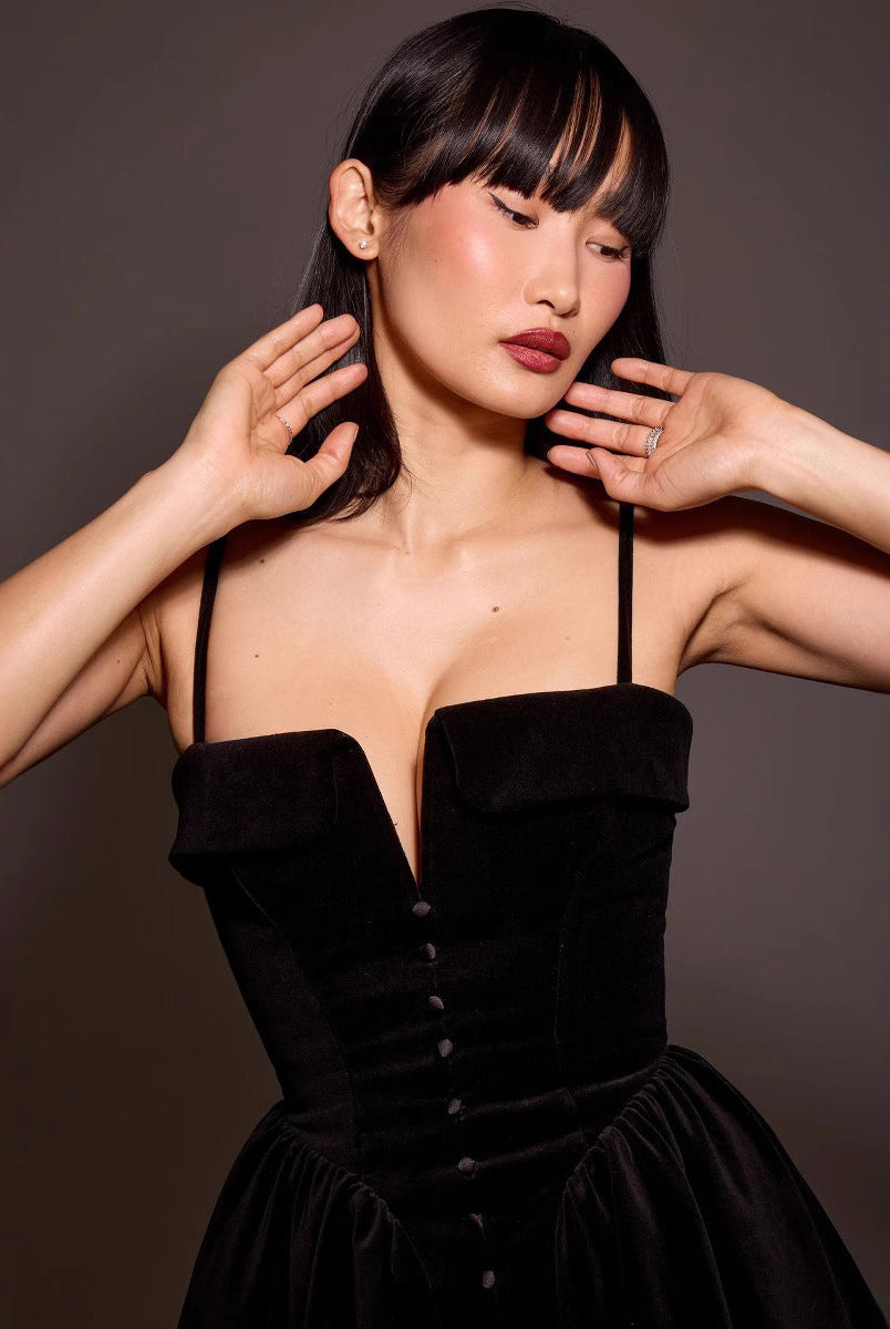Black Elara Velvet A-Line Mini Dress by Lumina Vancouver, shown on a model in a close-up view of the dress's soft fabric and elegant fit.
