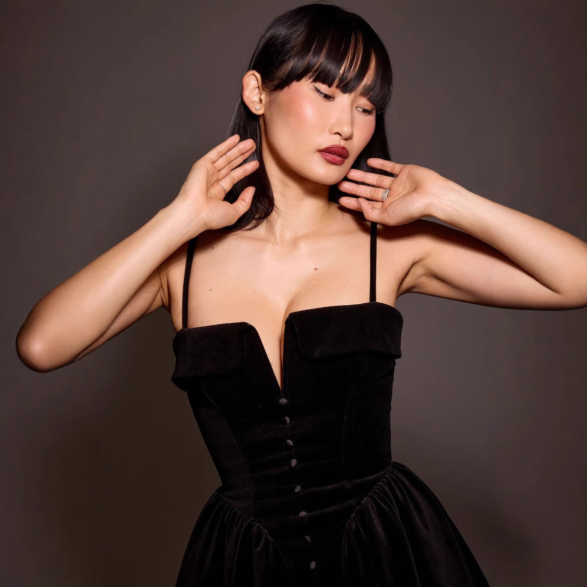 Black Elara Velvet A-Line Mini Dress by Lumina Vancouver, shown on a model in a close-up view of the dress's soft fabric and elegant fit.