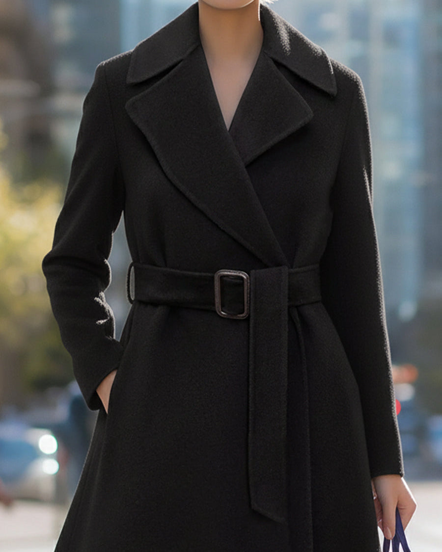 Black Lumina Wear Edith wool-blend midi coat with belted lapel collar, shown on a model, front view, size XS.