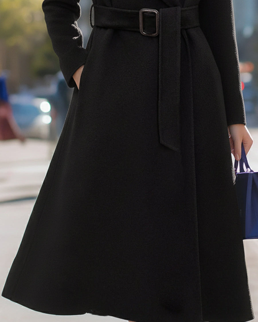 Black Lumina Wear Edith wool-blend midi coat with belt and lapel collar, shown on a model, stylish and warm for winter.