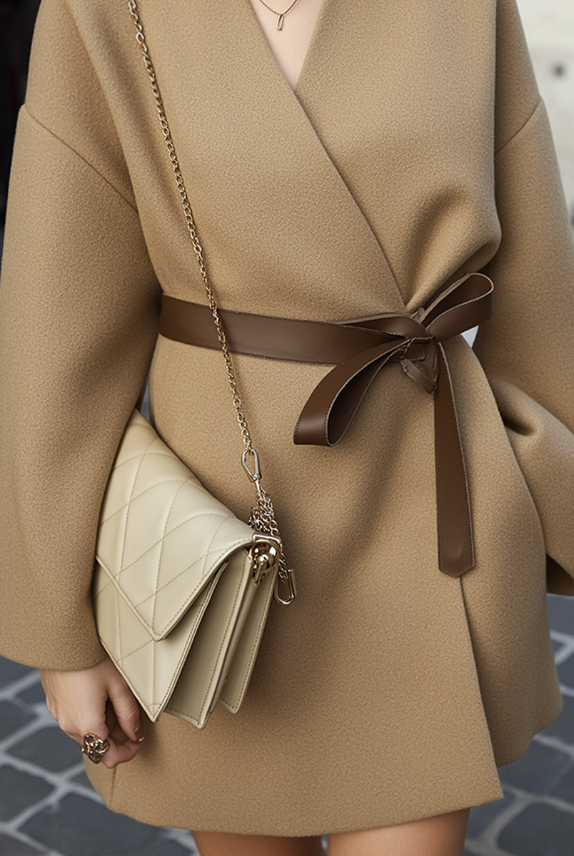 Camel belted short coat from Lumina Vancouver's Millicent collection, shown on a model, featuring a structured silhouette and stylish lapel.