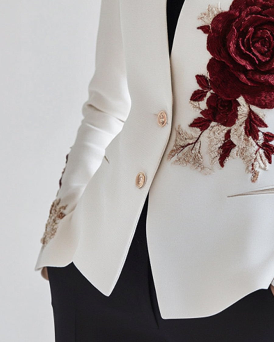 White blazer with red rose embroidery by Lumina Wear, featuring tailored fit and stylish floral detail.
