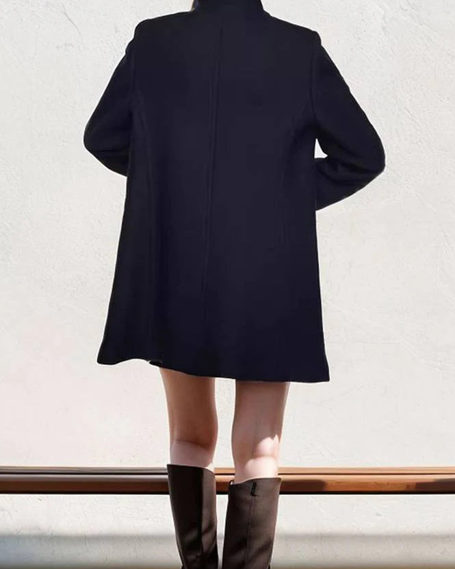 Navy blue Elena collar maxi structured coat by Lumina Wear, featuring a tailored design and long sleeves, displayed on a hanger.