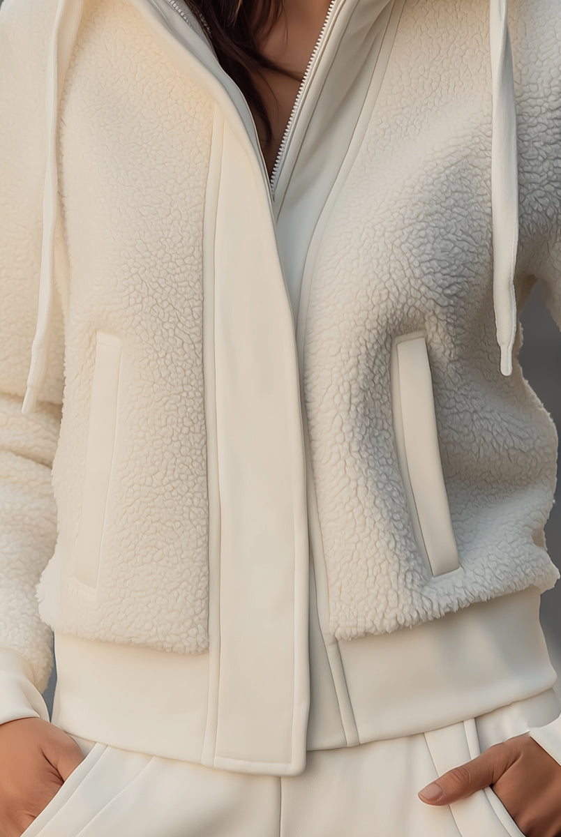 White Lumina Vancouver Ivy hooded jacket with contrast trim and fleece patchwork, shown on a model in size XS.