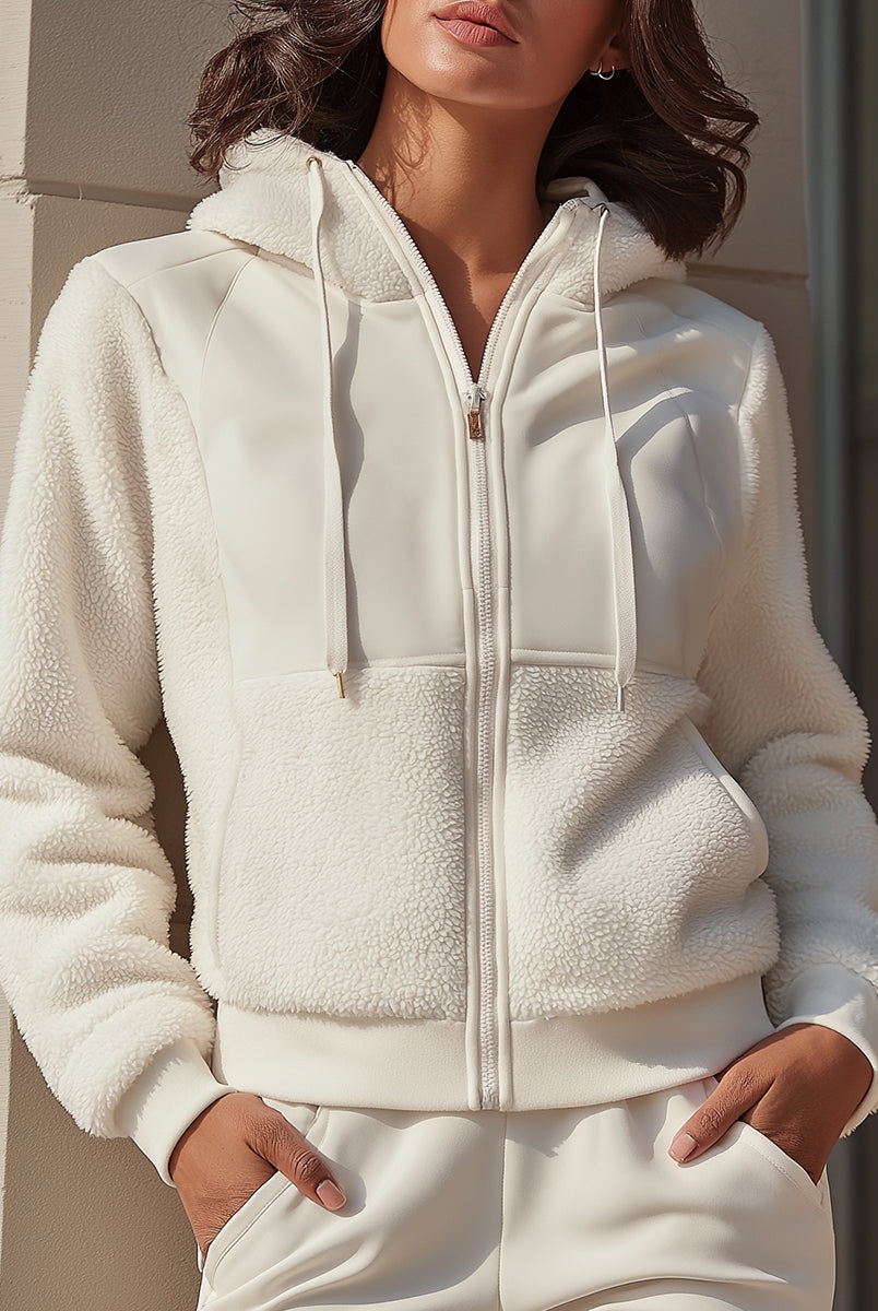 White Lumina Vancouver Ida hooded jacket with zip front and fleece panels, shown on a model in size XS.