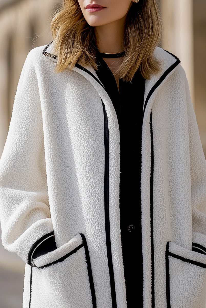 Longline Harlow wool-blend coat with contrast piping in white, designed by Lumina Vancouver, showcases a stylish, tailored silhouette.