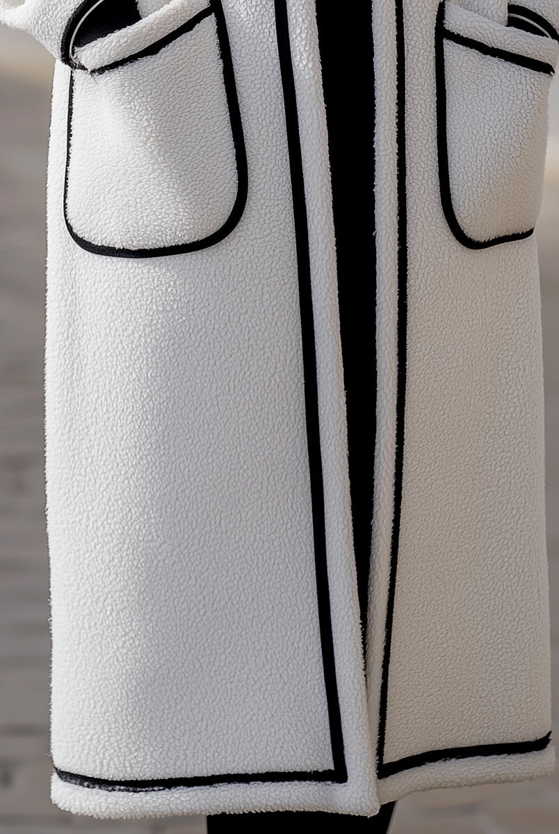 Longline Harlow wool-blend coat with contrast piping in white, designed by Lumina Vancouver, featuring a tailored fit and classic style.