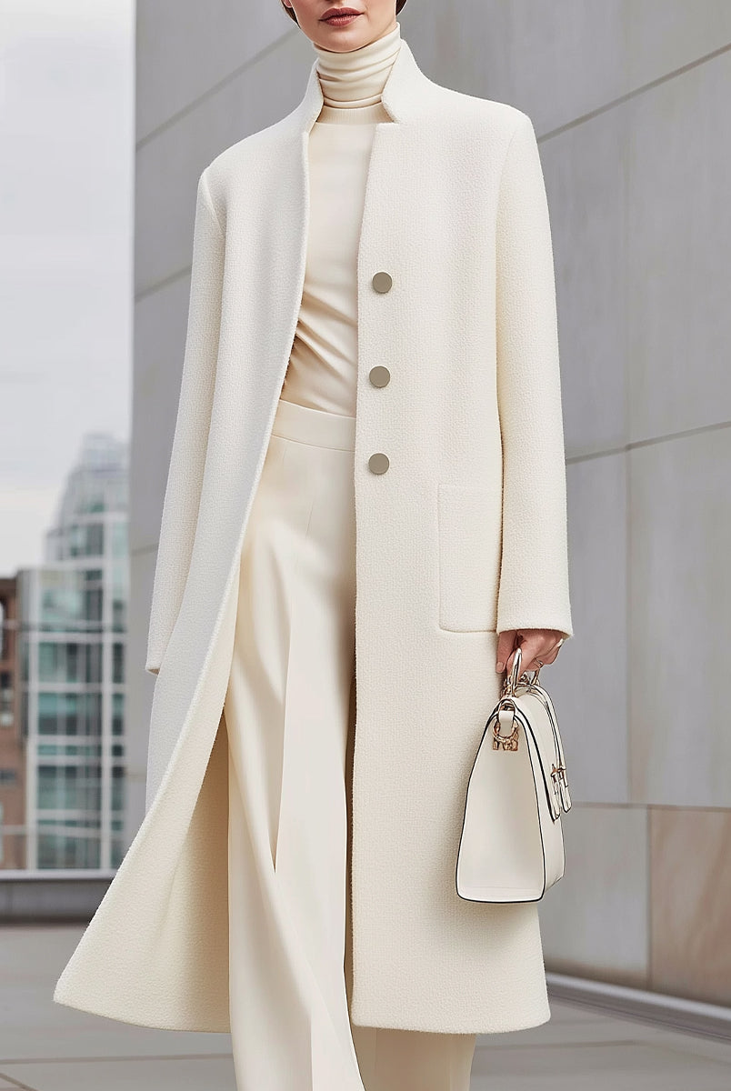 Elena wearing the Lumina Vancouver Ottilie longline wool coat in white, showcasing its tailored fit and cozy winter style.