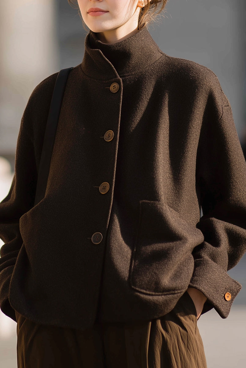 Chocolate stand-collar jacket by Lumina Vancouver, featuring a sleek design and tailored fit, worn by Elena.