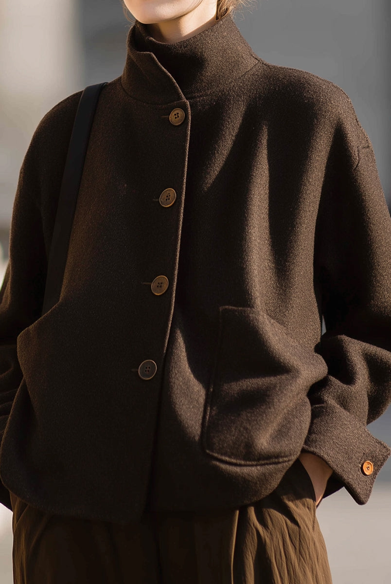 Chocolate stand-collar jacket by Lumina Vancouver, featuring a stylish design and snug fit, worn by Elena.