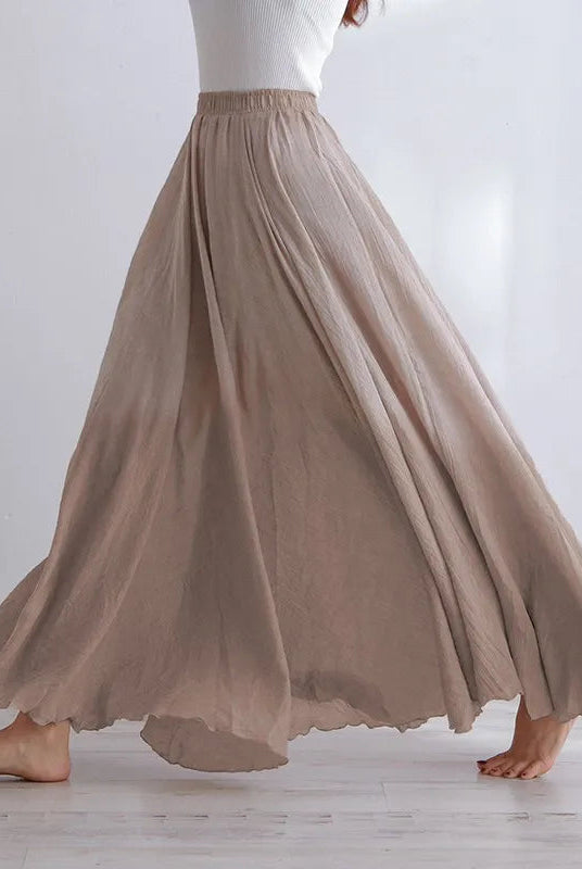 Elegant beige maxi skirt with high waist from Lumina Wear, featuring flowing fabric and a stylish silhouette.