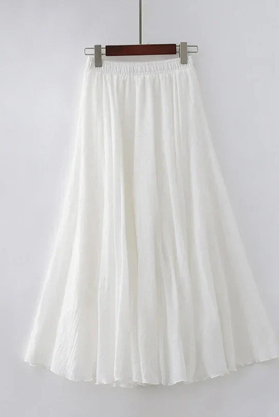 Elegant beige maxi skirt with high waist from Lumina Wear, displayed on a mannequin, showcasing flowing fabric and stylish fit.