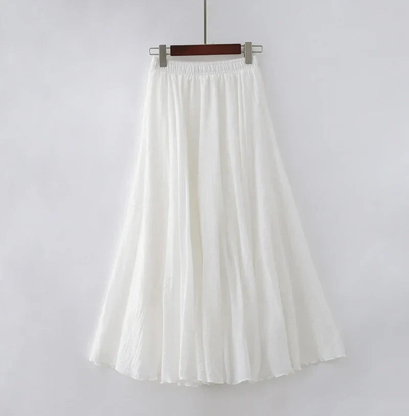 Elegant beige maxi skirt with high waist from Lumina Wear, displayed on a mannequin, showcasing flowing fabric and stylish fit.