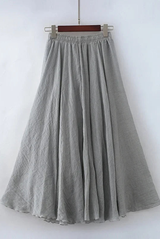 Elegant beige maxi skirt with high waist from Lumina Wear, shown in a flowing fabric and stylish design.