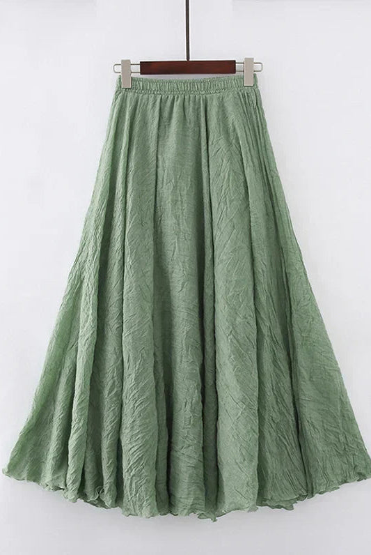 Elegant beige maxi skirt with high waist by Lumina Wear, showcased flowing in a natural pose.