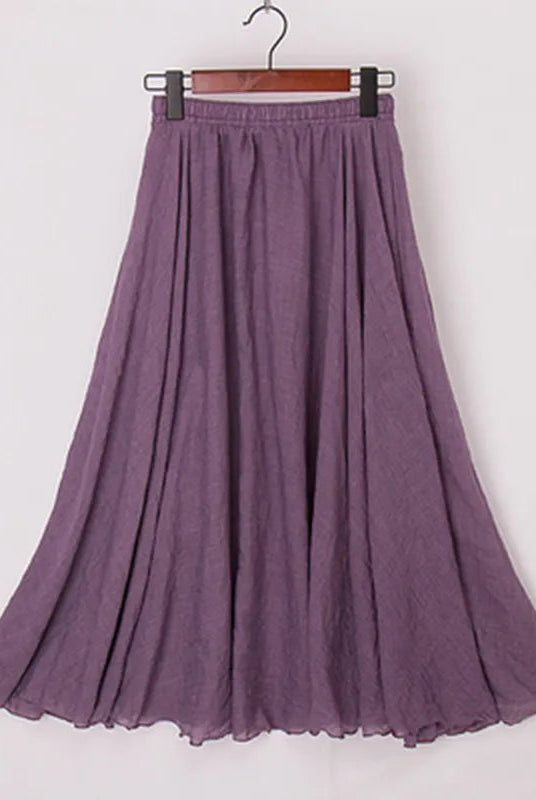 Elegant beige high-waist maxi skirt from Lumina Wear, flowing fabric with a stylish, sophisticated silhouette.