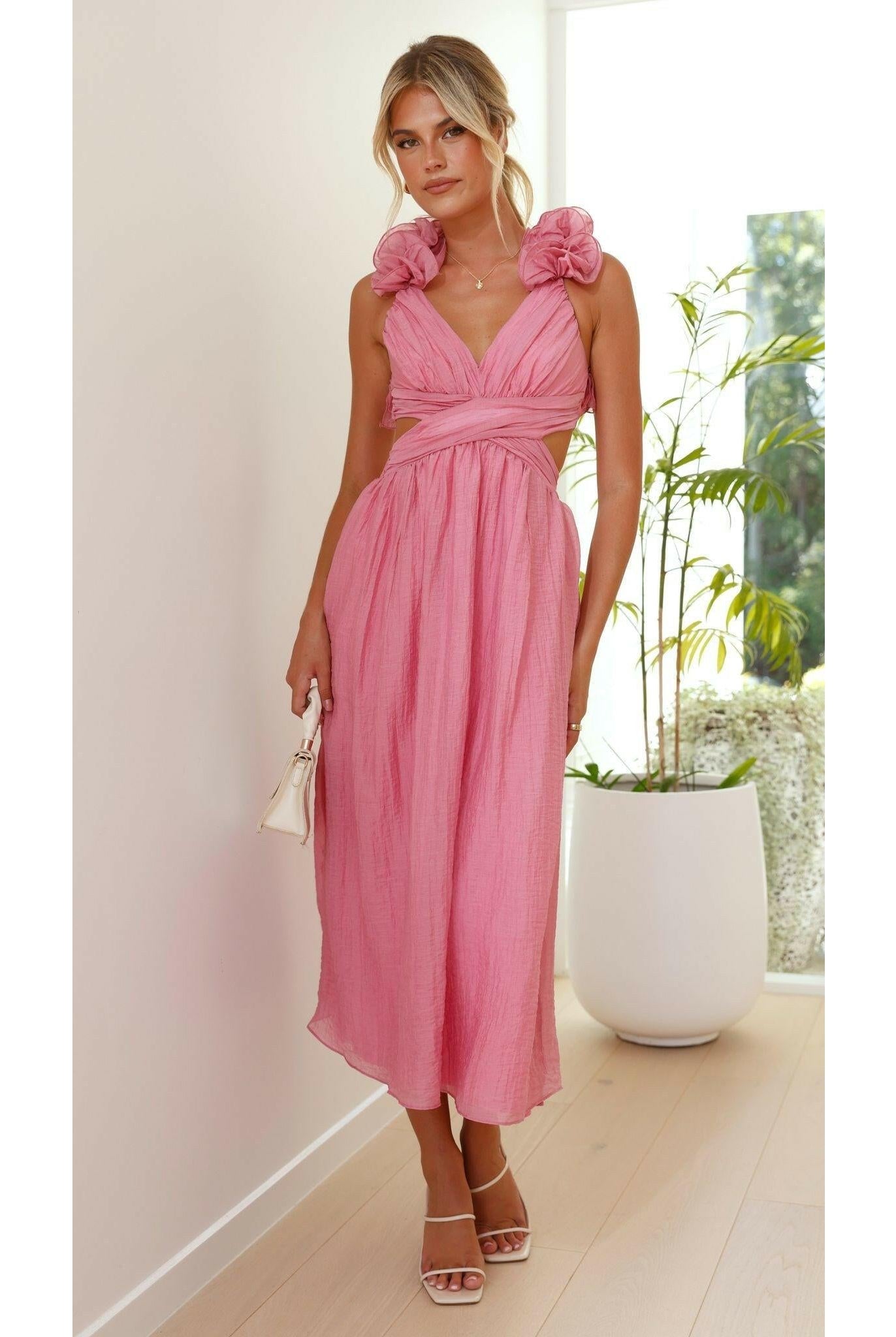 Pink Severine elegant summer dress by Lumina Wear, featuring flowing fabric perfect for wedding guest or warm-weather occasions.