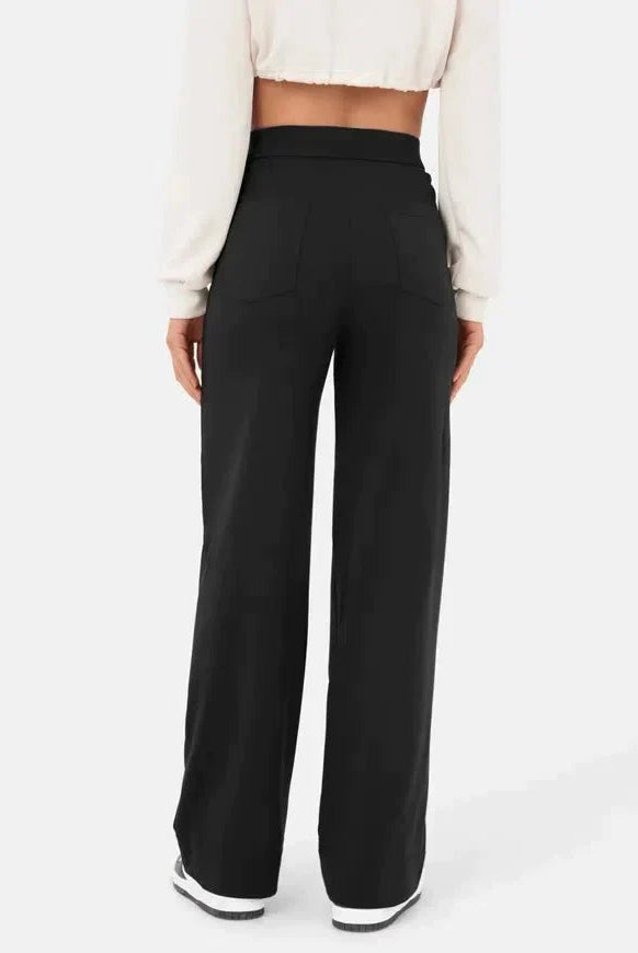 Elsa Lumina Wear high-waist black trousers with pockets, comfortable fit, stylish for casual or professional wear.