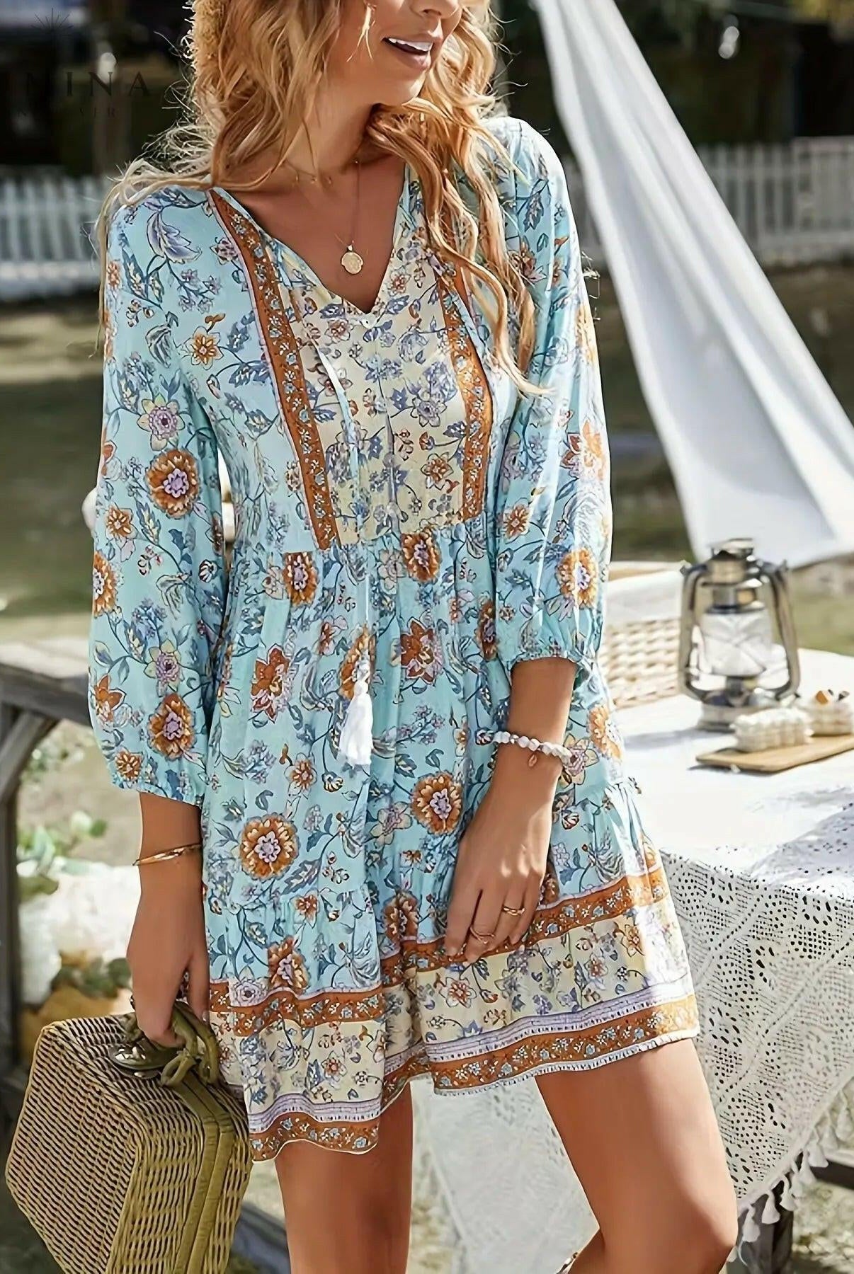 Sky blue Katariina boho dress by Lumina Wear, flowing fabric with intricate patterns, worn by a model.