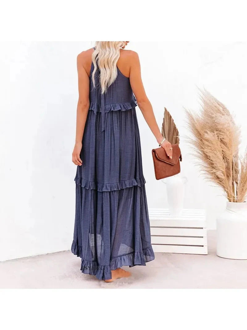 Laila halter ruffle maxi dress in apricot by Lumina Vancouver, flowing fabric with ruffle details, perfect for summer occasions.