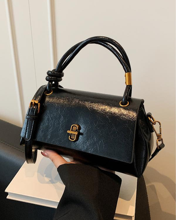 Black Lumina Wear Emma satchel handbag with versatile design and optional crossbody strap, stylish and functional for everyday use.