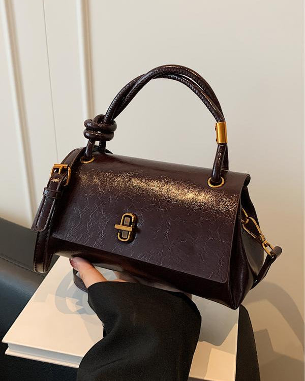 Black Lumina Wear Emma chic versatile handbag with crossbody strap, featuring sleek design and spacious interior.