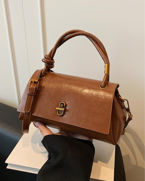 Black Lumina Wear Emma handbag with chic versatile satchel design and crossbody strap, stylish and functional for everyday use.