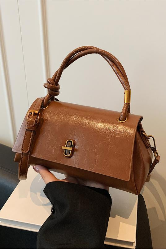 Black Lumina Wear Emma chic versatile satchel handbag with crossbody strap, featuring a sleek design and multiple carrying options.