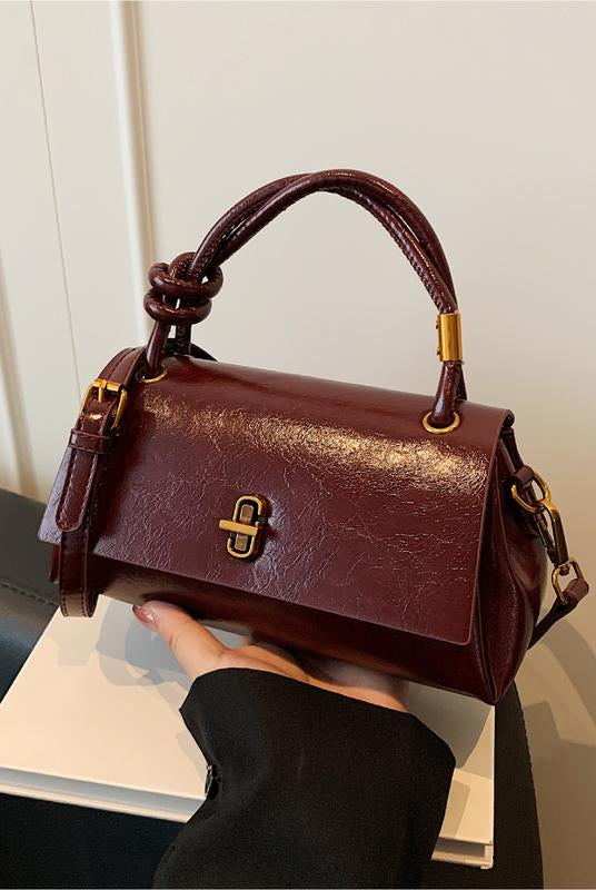 Black Lumina Wear Emma versatile satchel handbag with crossbody strap, stylish and practical for everyday use.