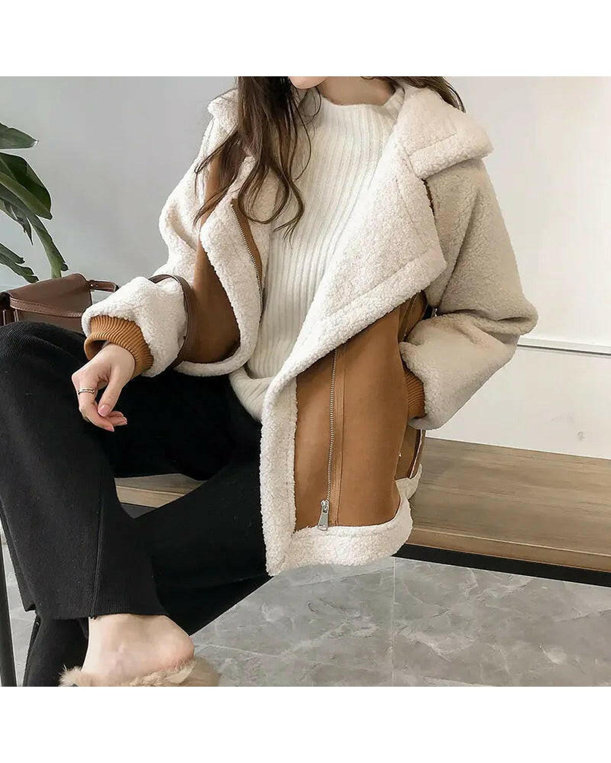 Beige Erin Lumina Wear faux shearling zip-up jacket with stylish collar and zipper details, displayed on a hanger.
