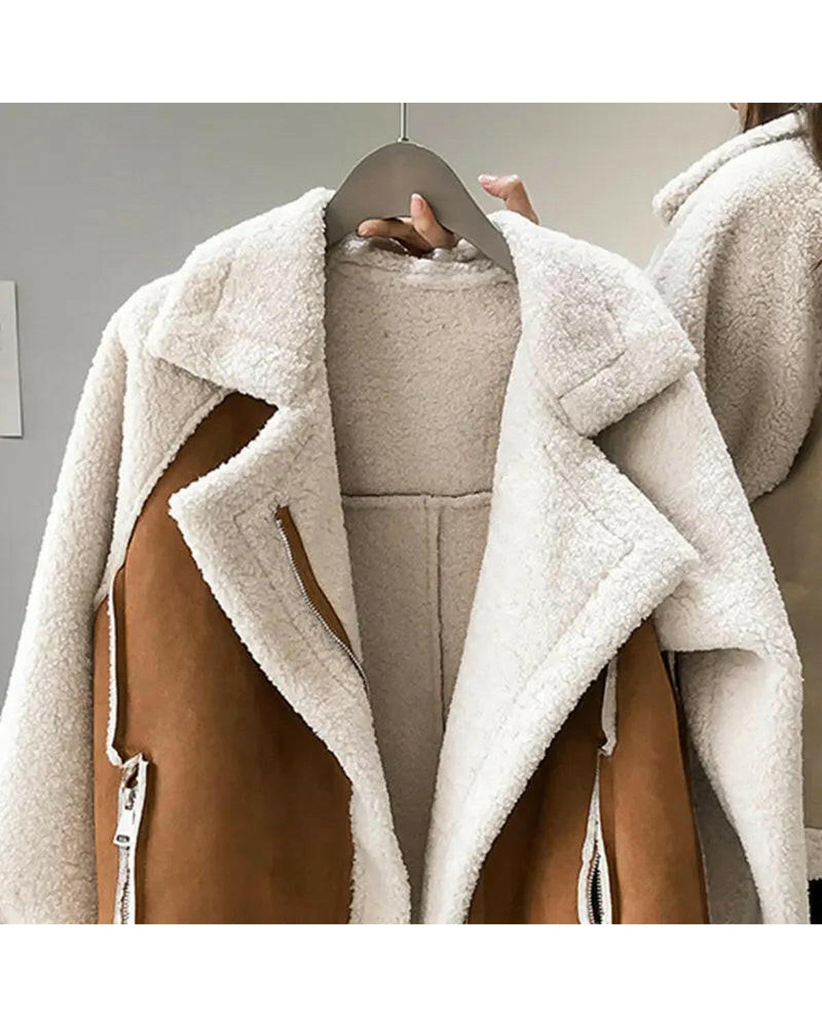 Beige Lumina Wear Erin stylish faux shearling zip-up jacket with a cozy collar and front zipper, displayed on a hanger.