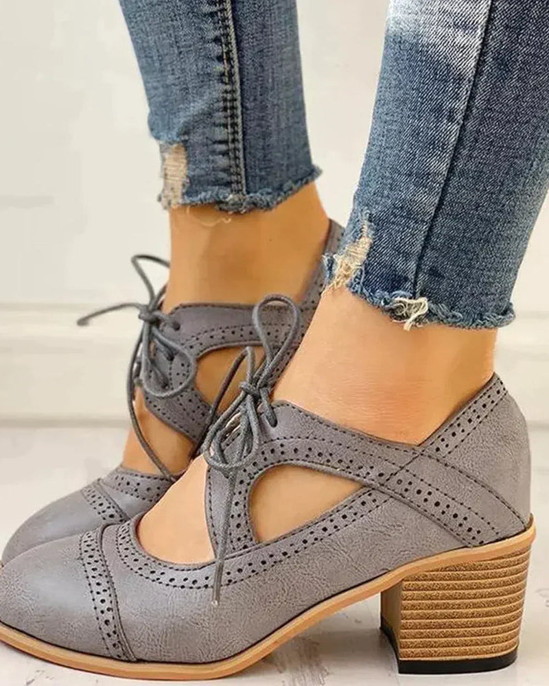 Black Evelyn T-strap heels by Lumina Wear, elegant women's shoes with a modern touch, showcasing sleek design and stylish heel.