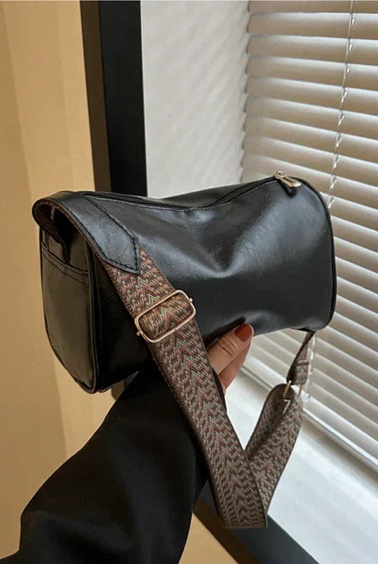 Lumina Wear Florence sleek minimalist crossbody bag with patterned strap, black leather, featuring adjustable strap and compact design.