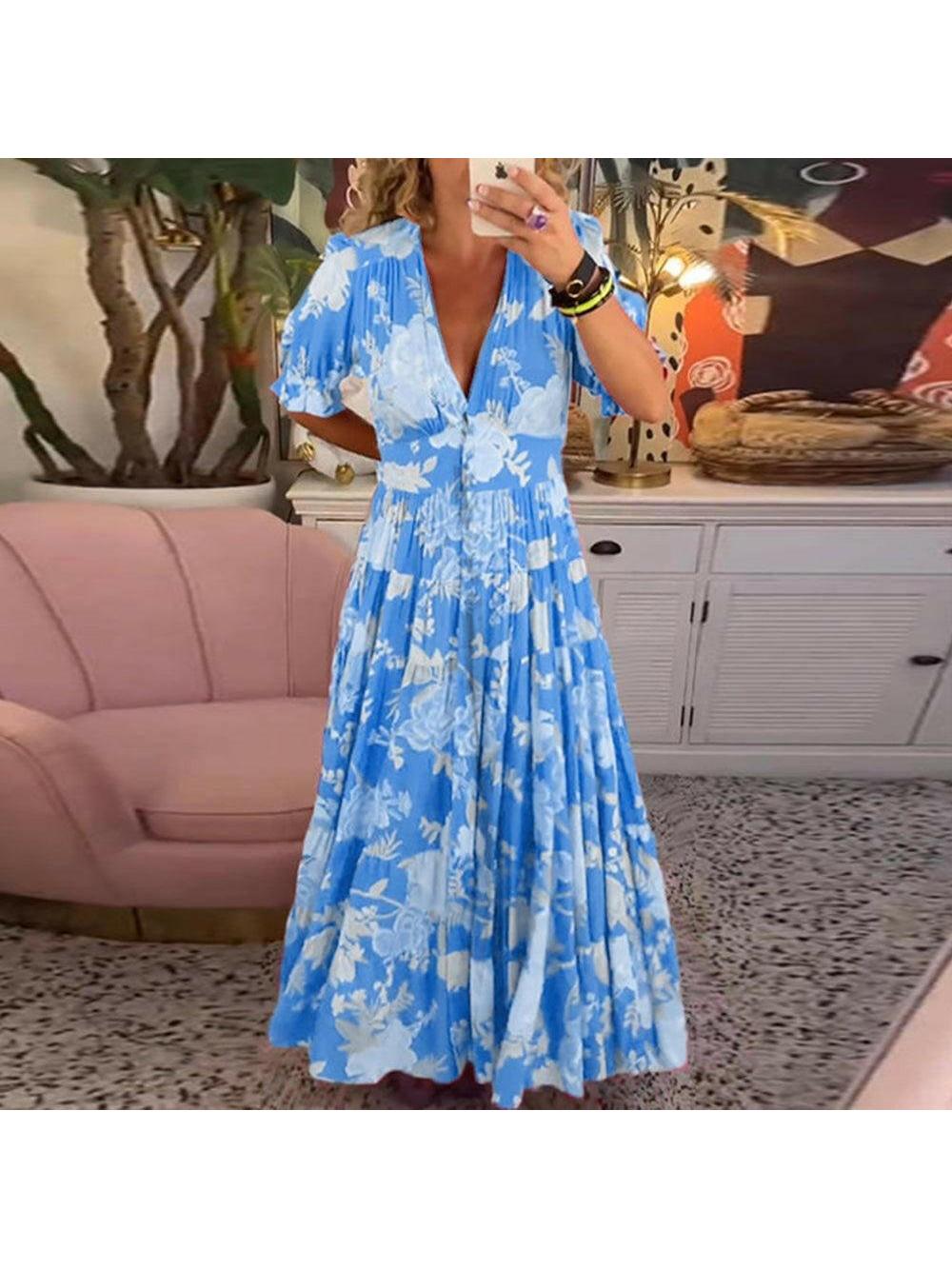 Red FLORIANA™ floral dress by Lumina Vancouver featuring vibrant flower patterns and a flowing design.