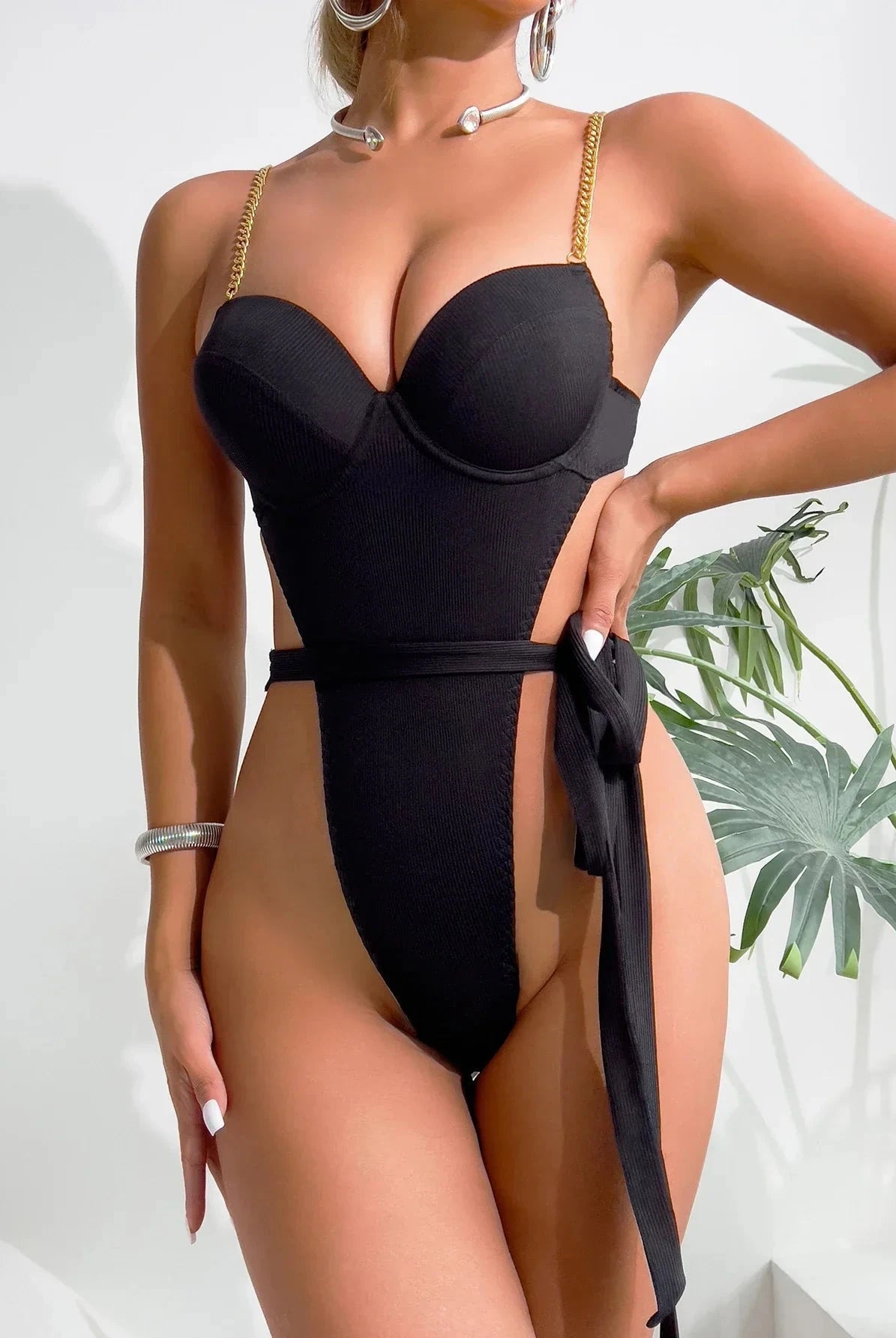 Lumina Wear Gabriella's Bodysuit, sleek black bodysuit with fitted design, shown on a model against a neutral background.