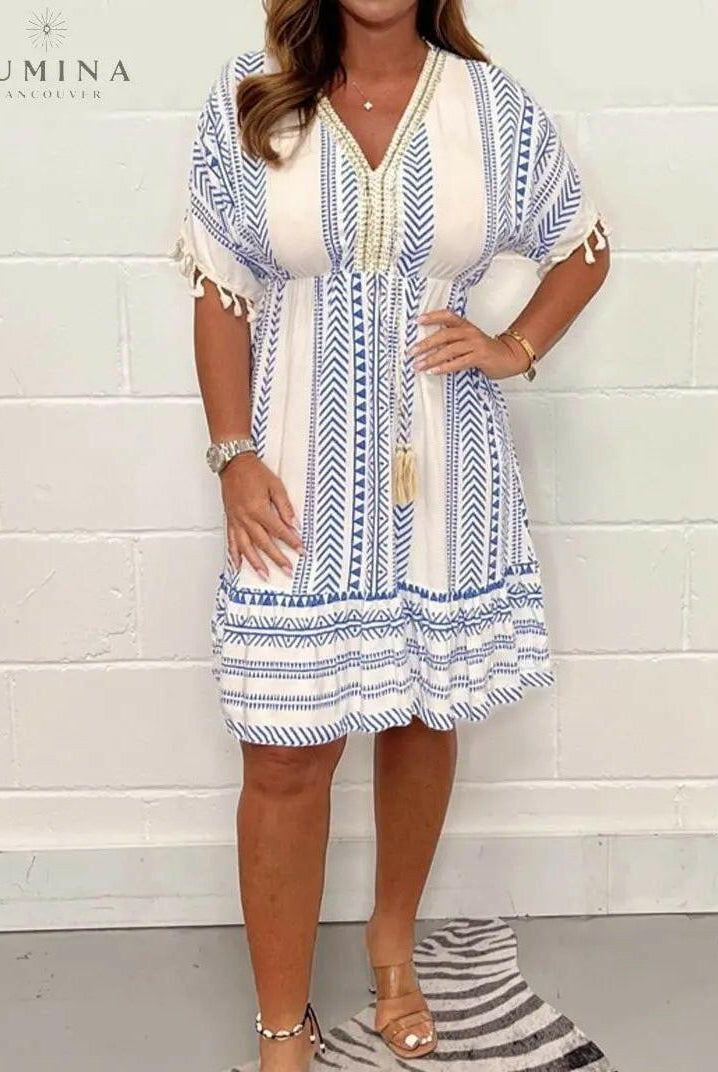 Blue Gail vintage dress by Lumina Wear featuring a fitted bodice and flowing skirt, displayed on a hanger.