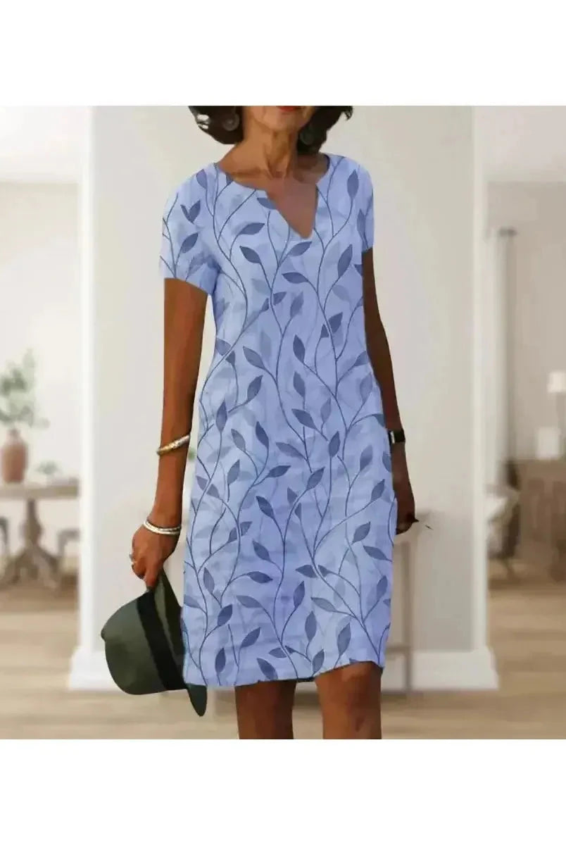 Green Galina casual elegant floral print dress by Lumina Vancouver, shown with a flattering fit and vibrant floral pattern.