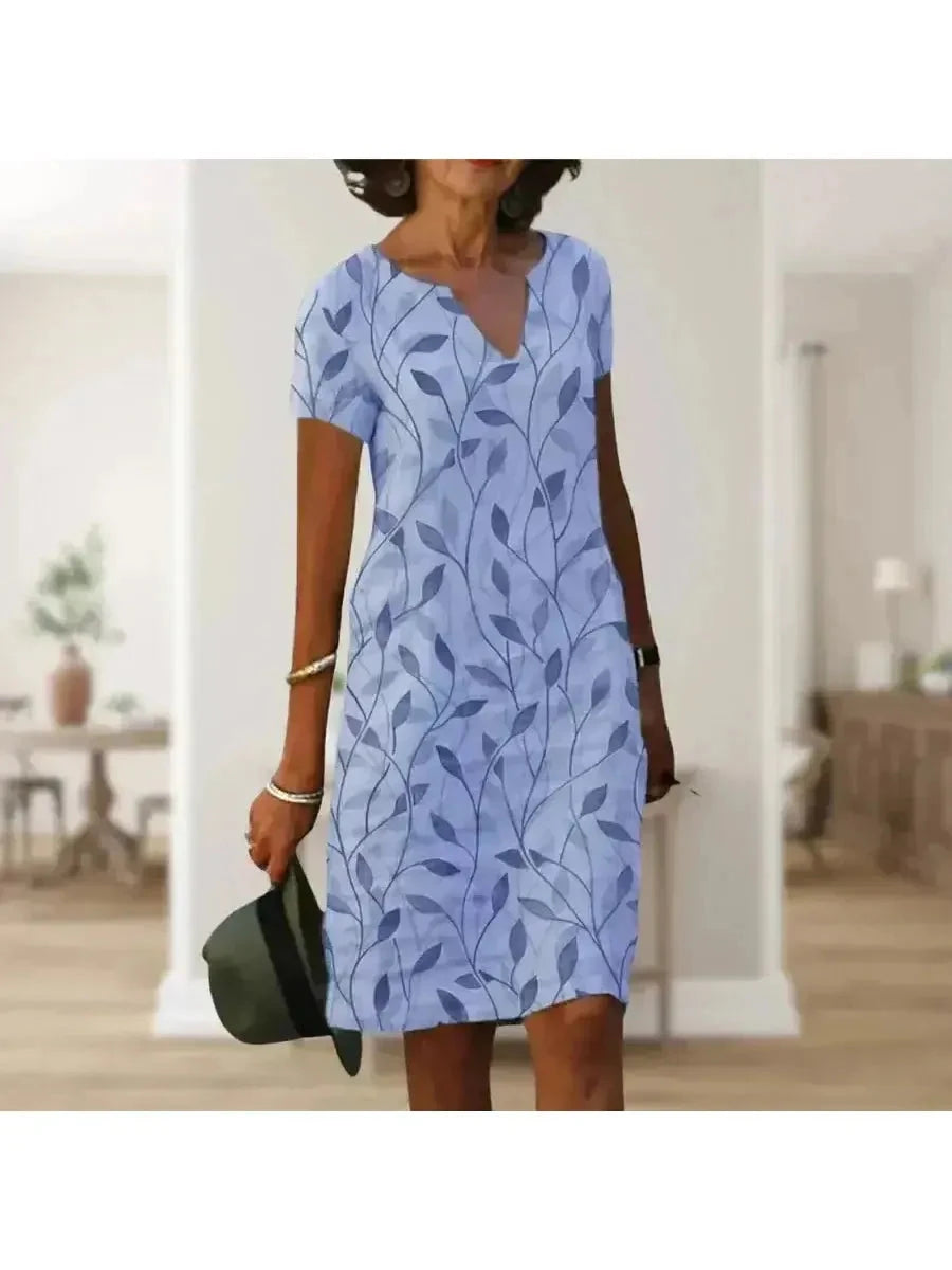 Green Galina casual elegant floral print dress by Lumina Vancouver, shown with a flattering fit and vibrant floral pattern.