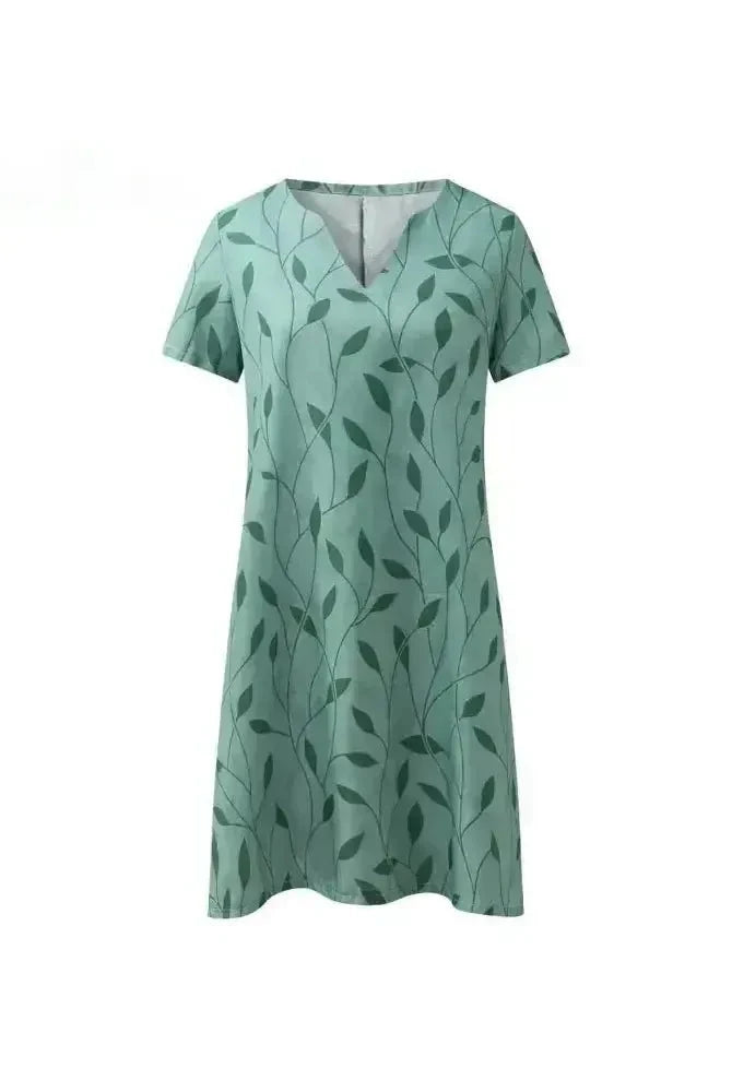Green Galina casual elegant floral print dress by Lumina Vancouver, featuring a fitted silhouette and lightweight fabric.