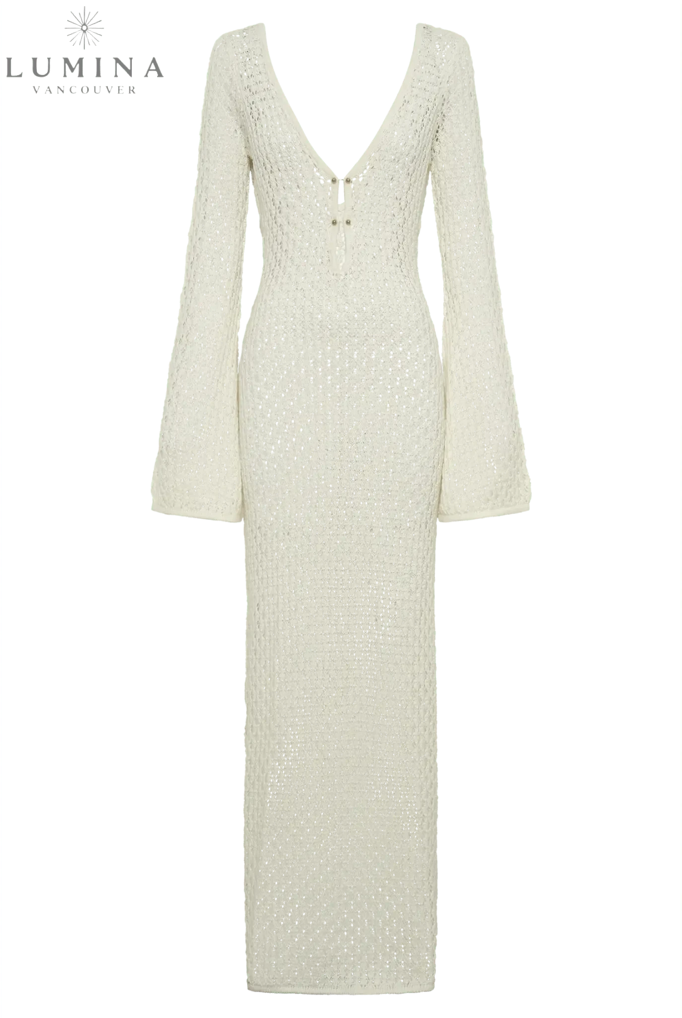 Elegant white dress by Lumina Wear, styled for holiday occasions, featuring a flowing design and chic details.