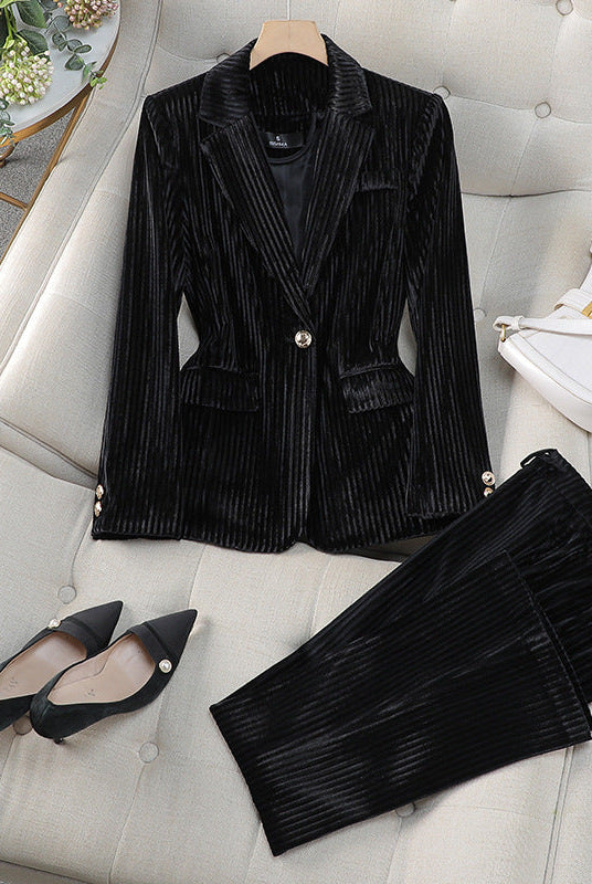Red women's tailored blazer and trousers set by Lumina Wear, featuring a polished silhouette for sophisticated style.