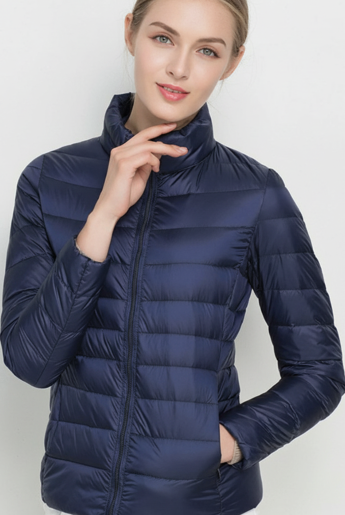 Harriet lightweight black puffer jacket with stand collar by Lumina Wear, shown in XS size with matcha color detail.