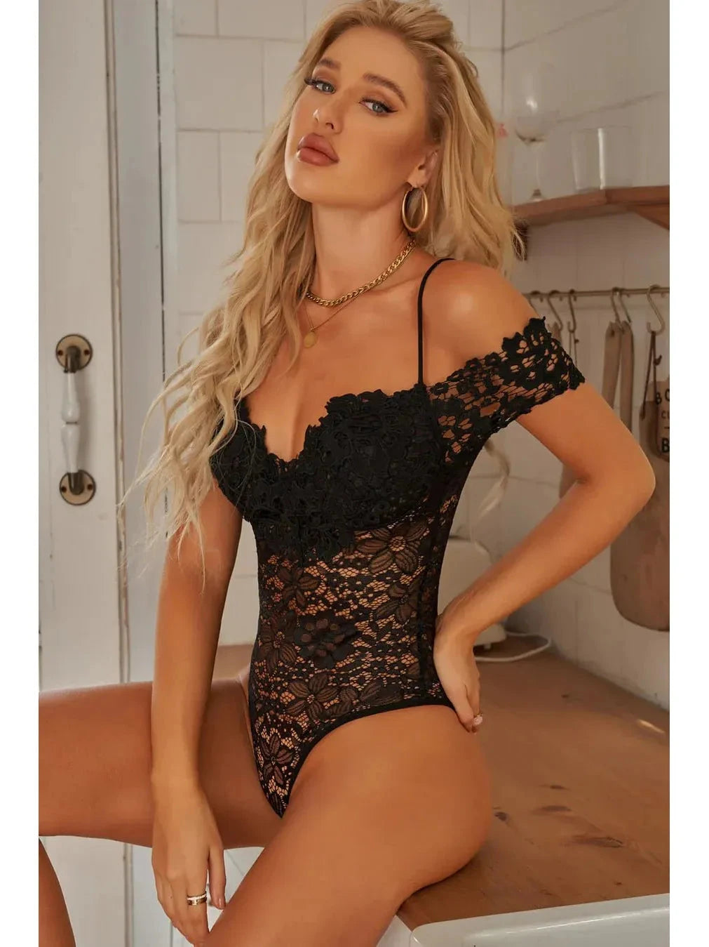 Lumina Vancouver Haven Bodysuit in sleek black, featuring a fitted design with long sleeves and scoop neckline.