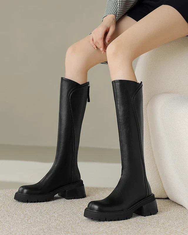 Elegant black knee-high boots with orthopedic support from Lumina Wear, featuring brown fur accents and a stylish design.
