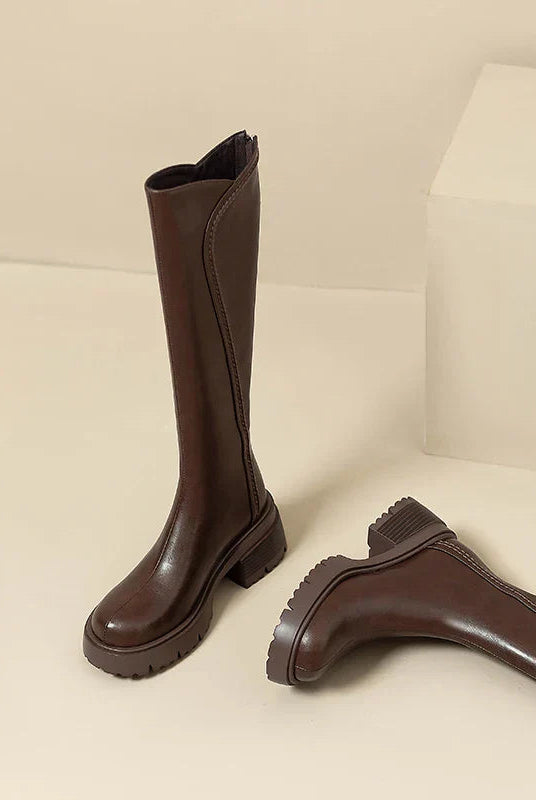 Elegant black knee-high women's boots by Lumina Wear with orthopedic support and brown fur trim.
