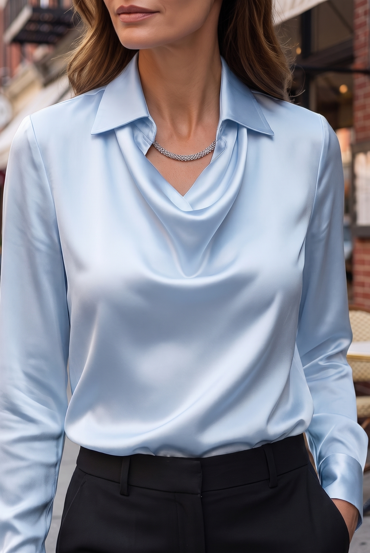 White Delphine blouse by Lumina Wear with draped fabric and long sleeves, styled on a mannequin.