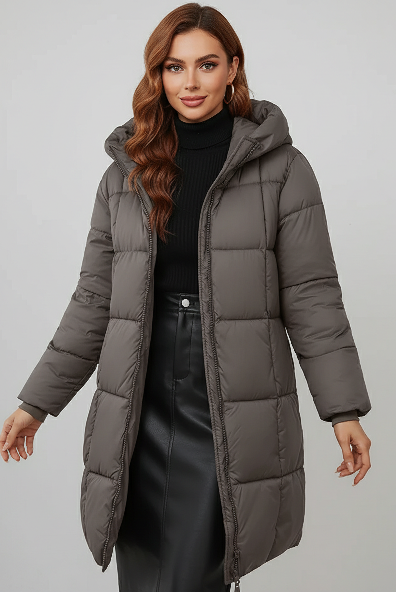 Redish-brown Holly Lumina longline hooded puffer coat with minimalist design, featuring a cozy, insulated look and a stylish silhouette.