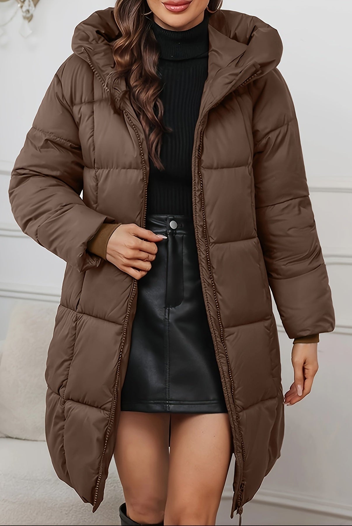 Redish-brown Holly Lumina Wear cozy longline hooded puffer coat with minimalist design, shown hanging with front view.