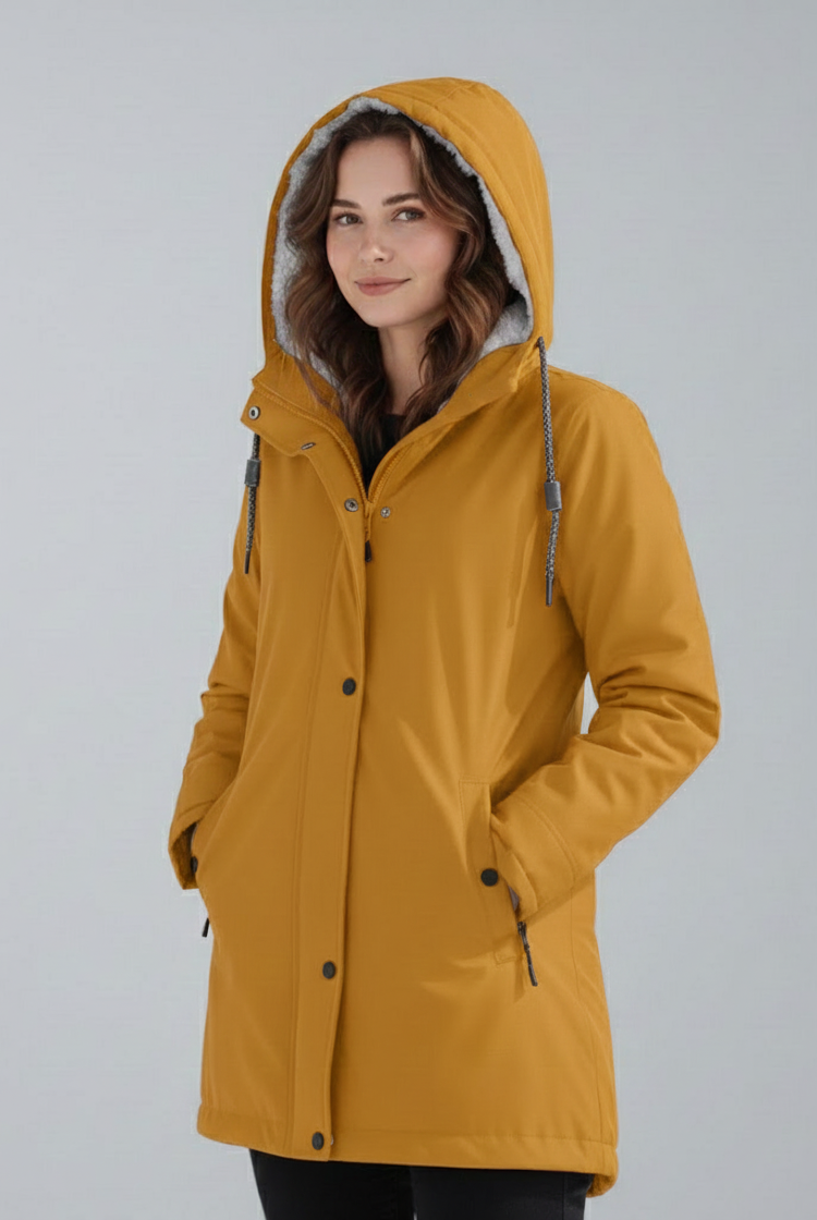 Yellow Lumina Wear Imogen cozy sherpa-lined hooded parka jacket for winter adventures, shown on a person outdoors.