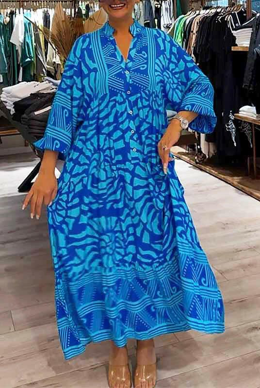 Blue Irene™ Vibrant Printed Dress by Lumina Vancouver, featuring bold floral patterns and a flowing silhouette.